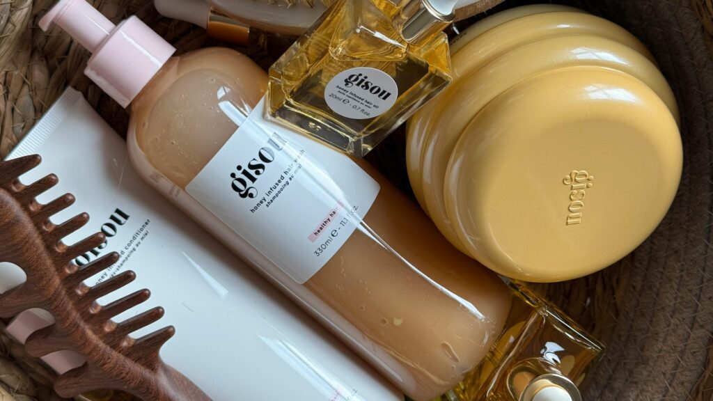 A stylish arrangement of Gisou hair products in a basket with natural aesthetics.